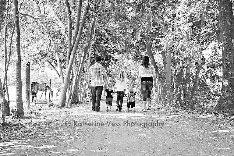 family holding hands taking a stroll in Davis, CA
