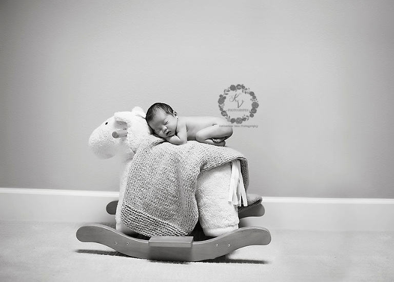 newborn on rocking horse
