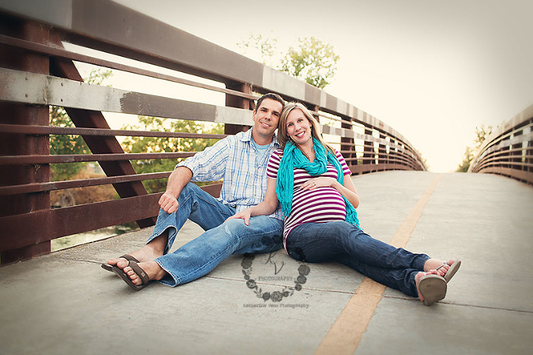 maternity couple on a bridge