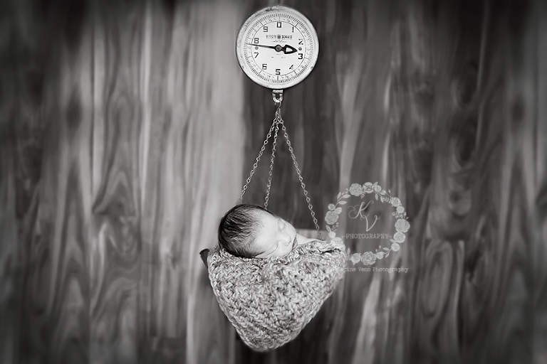 newborn in scale