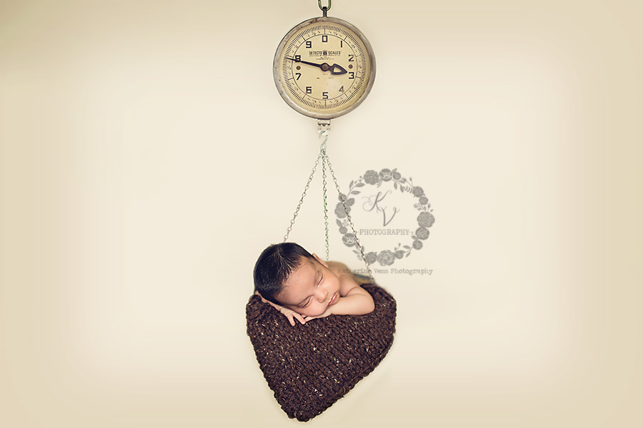 newborn in hanging scale