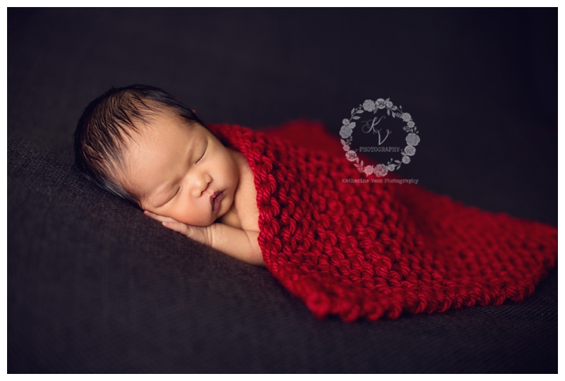 newborn with gray and red