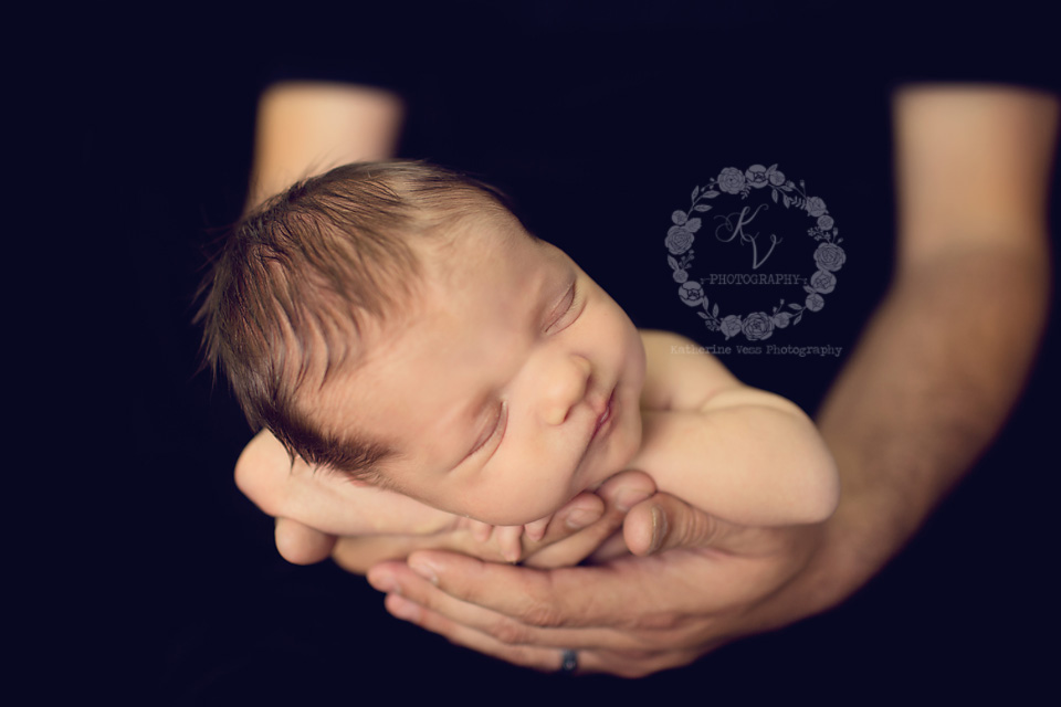 newborn in daddy's hands