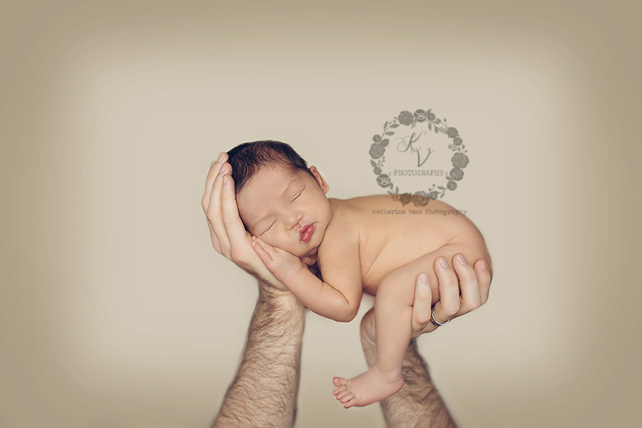 baby boy in daddy's hands