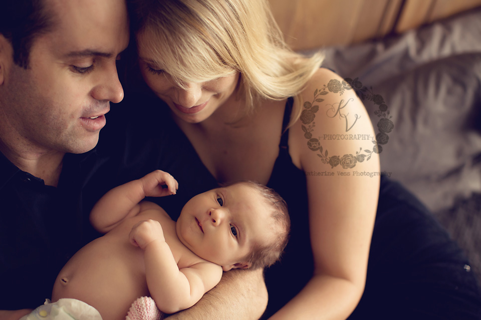 awake newborn with parents