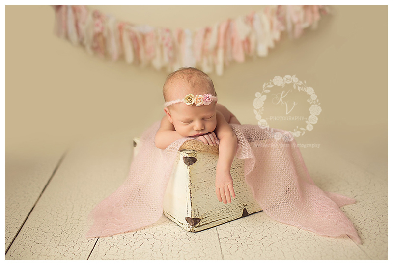 newborn baby girl in wood box, rag tie banner