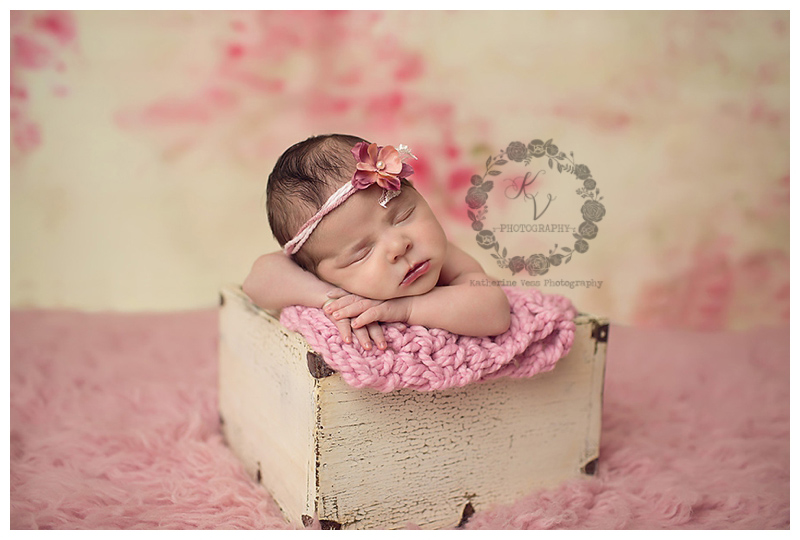 newborn in wood box, floral background
