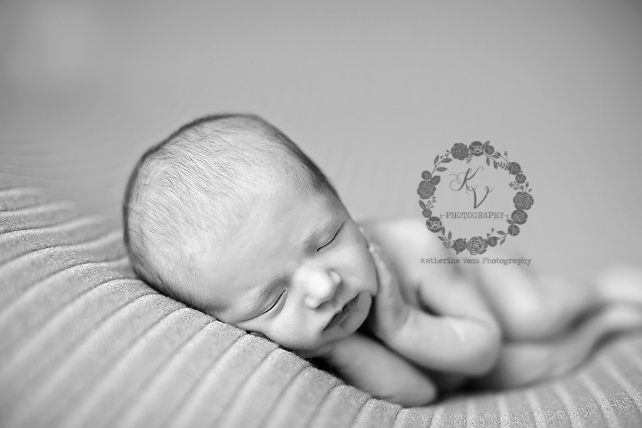 newborns hands on cheeks