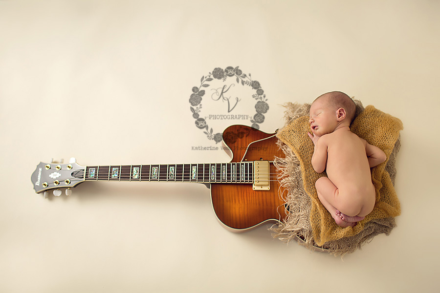 newborn on guitar from above
