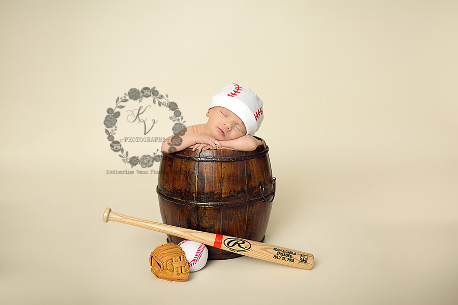 newborn with baseball setup