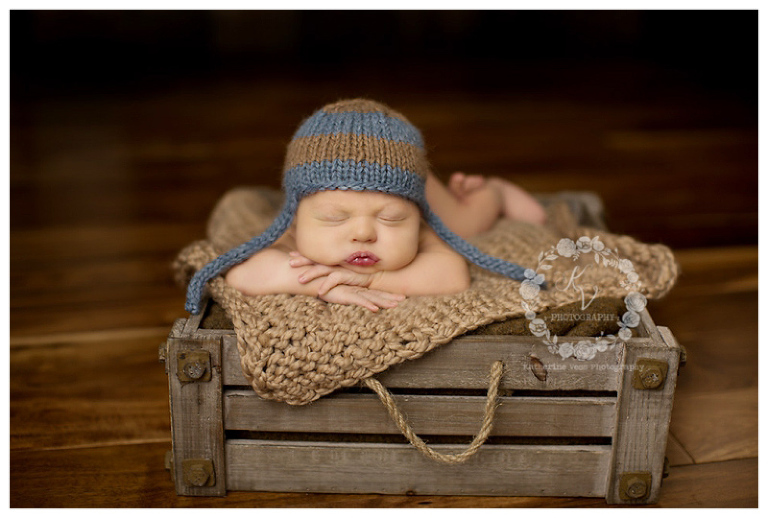newborn in wood crate