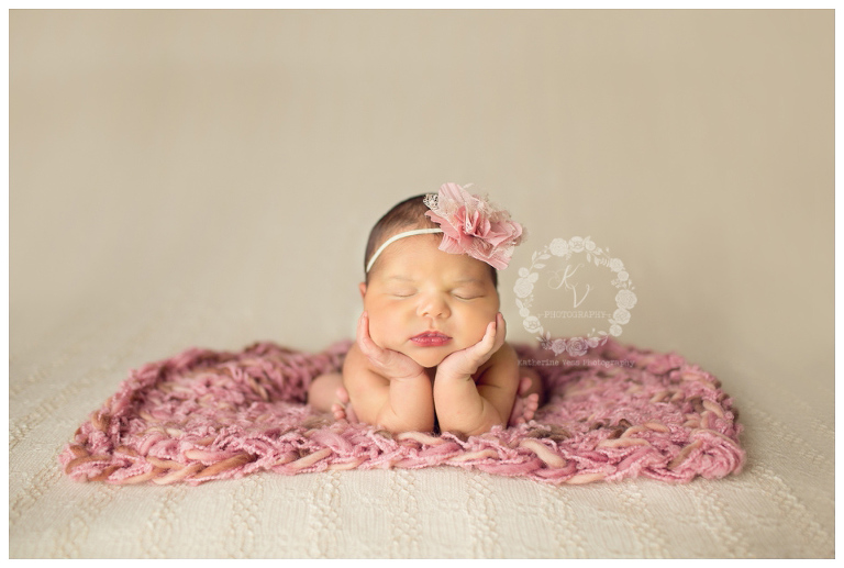 newborn head in hands 