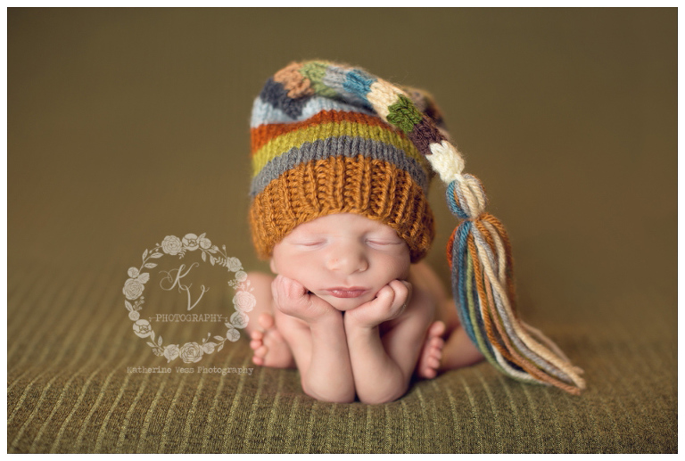 newborn boy in froggie pose, tassel hat