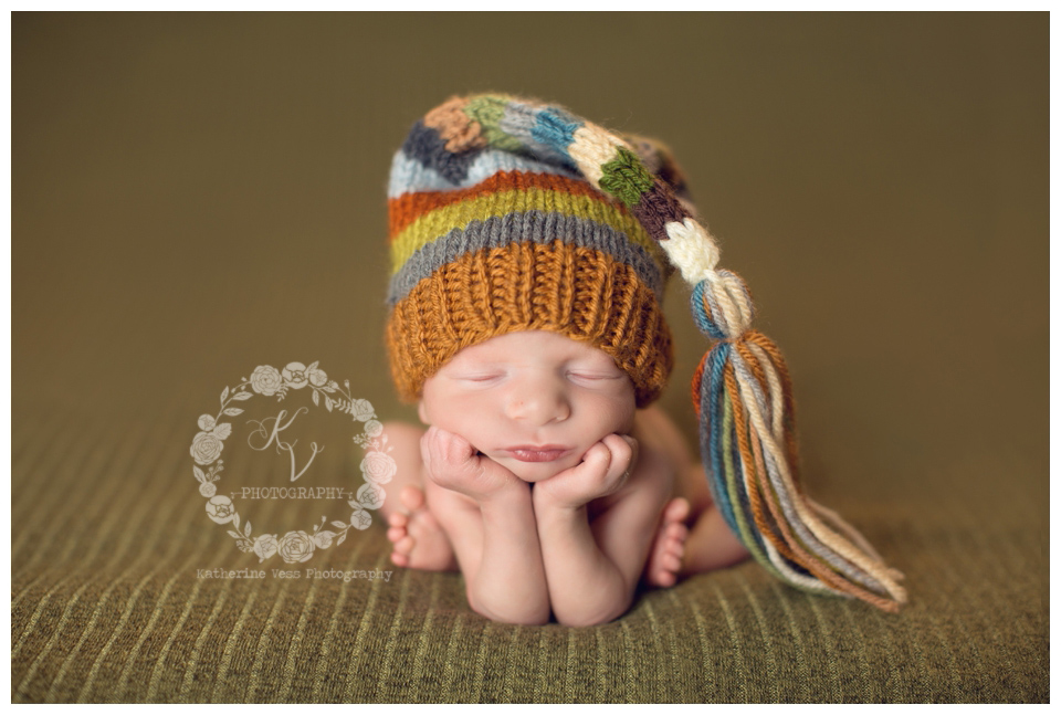 newborn boy in froggie pose, tassel hat